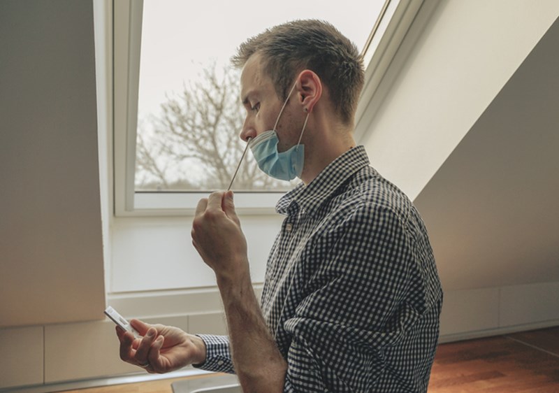 MAN DOING CORONAVIRUS TEST AT HOME