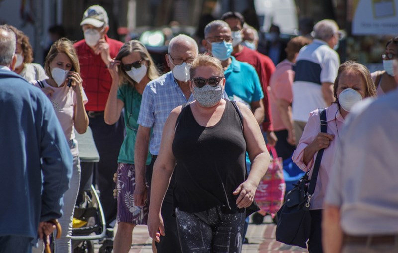 GROUP OF PEOPLE WITH PROTECTIVE MASKS ON THE STREET