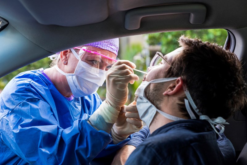 DOCTOR TAKING A NASAL SWAB FROM A DRIVER