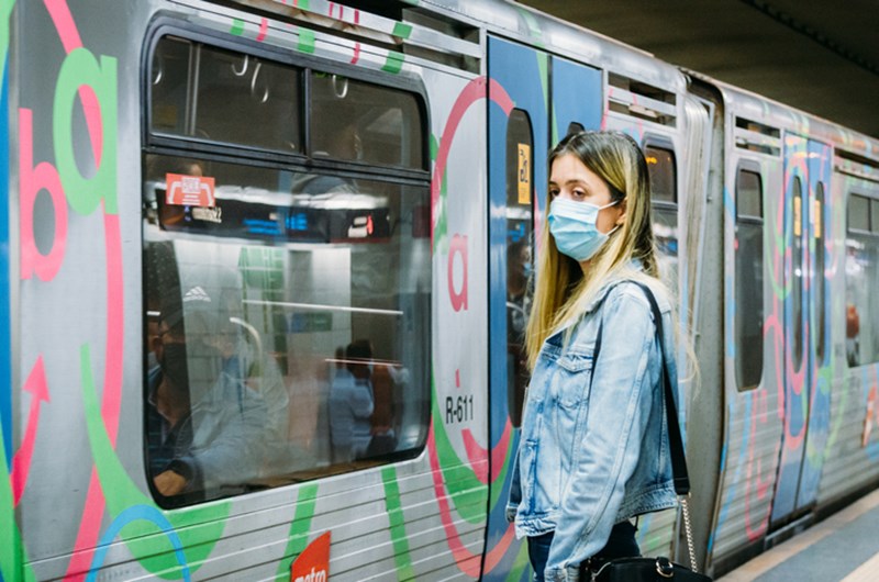 BEAUTIFUL WOMAN WITH PROTECTIVE FACE MASK, IN A METRO STATION