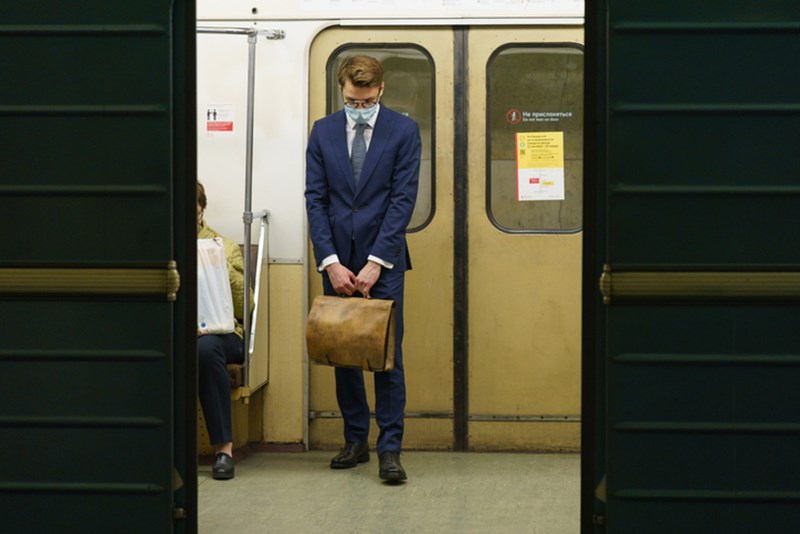 MAN WITH PROTECTIVE FACE MASK IN THE SUBWAY