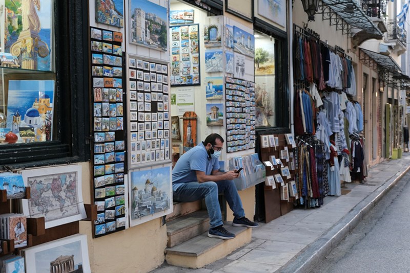 MAN WITH FACE MASK AT MONASTIRAKI