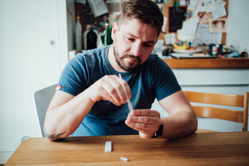 MAN DOING A RAPID TEST
