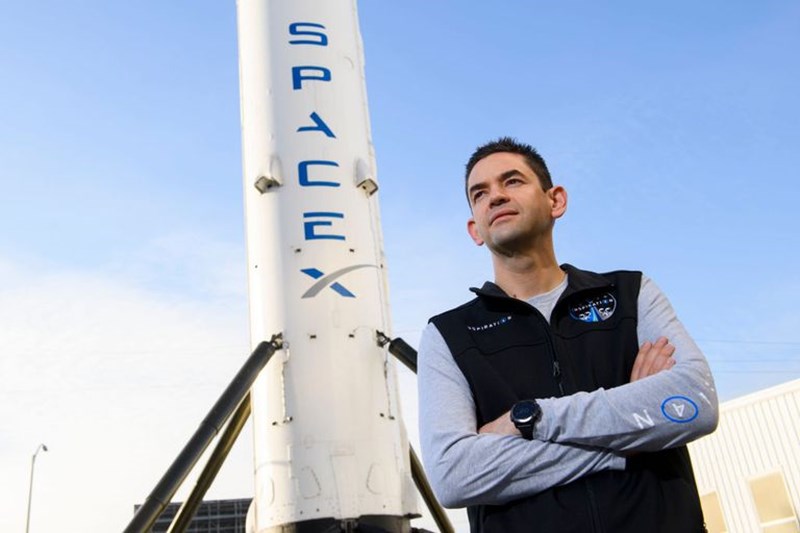 JARED ISAACMAN POSING NEXT TO SPACEX SPACE CRAFT