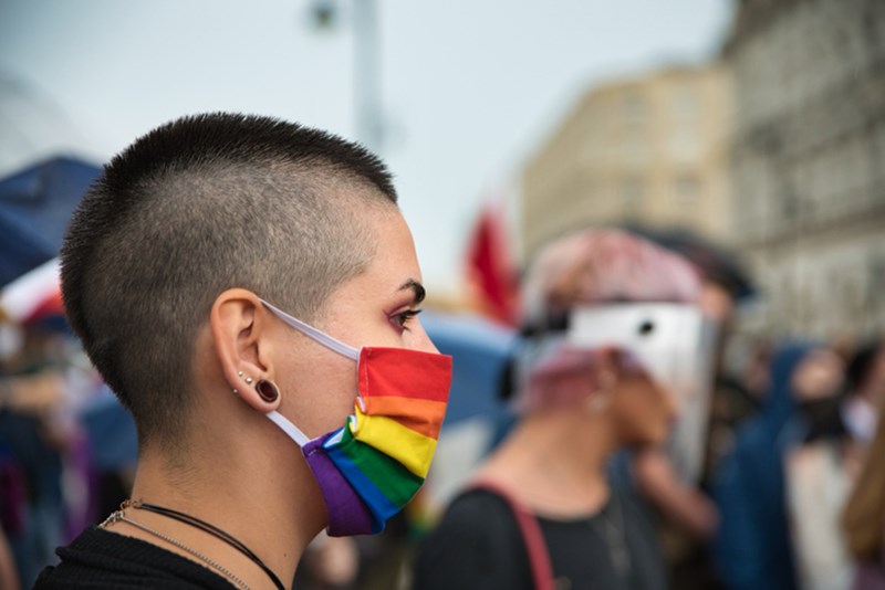 WOMAN WITH PROTECTIVE MASK IN RAINBOW COLORS