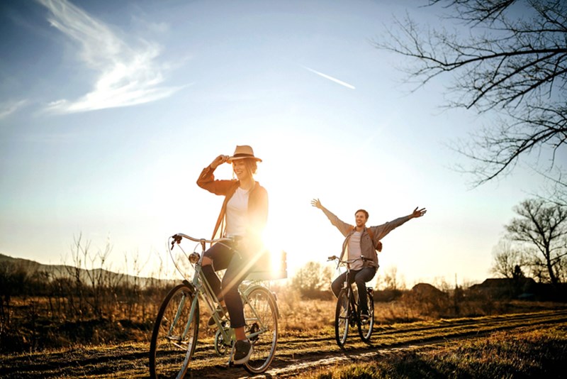 COUPLE DRIVING ON BICYCLE IN NATURE