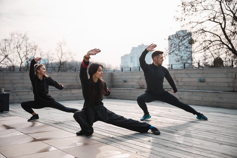 THREE PEOPLE DOING TAI CHI