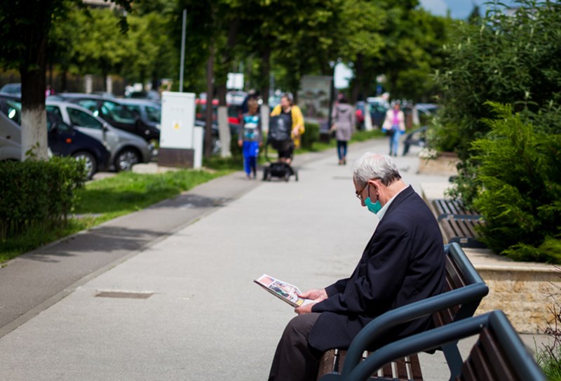 SENIOR MAN WITH FACE MASK IN PUBLIC SPACE