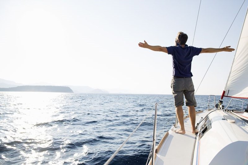 IMAGE OF A HAPPY MAN SAILING IN THE SEA