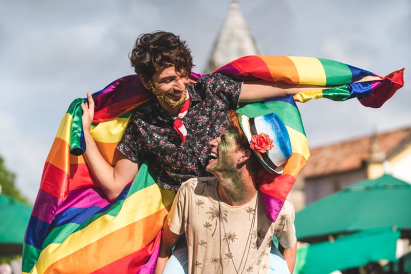COUPLE WITH RAINBOW FLAG