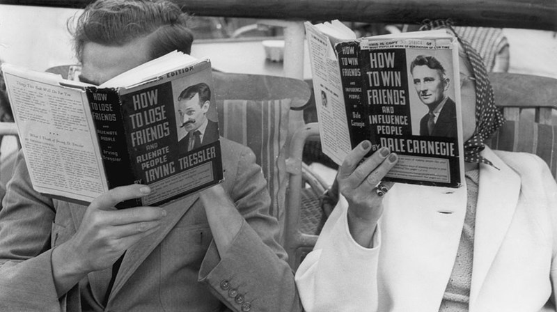 COUPLE READING 'ALMOST' THE SAME BOOK