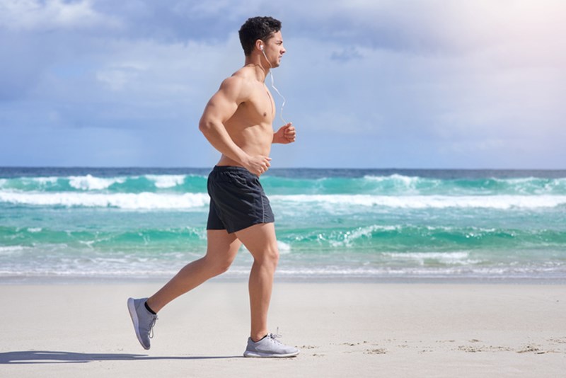 MAN JOGGING BY THE SEA