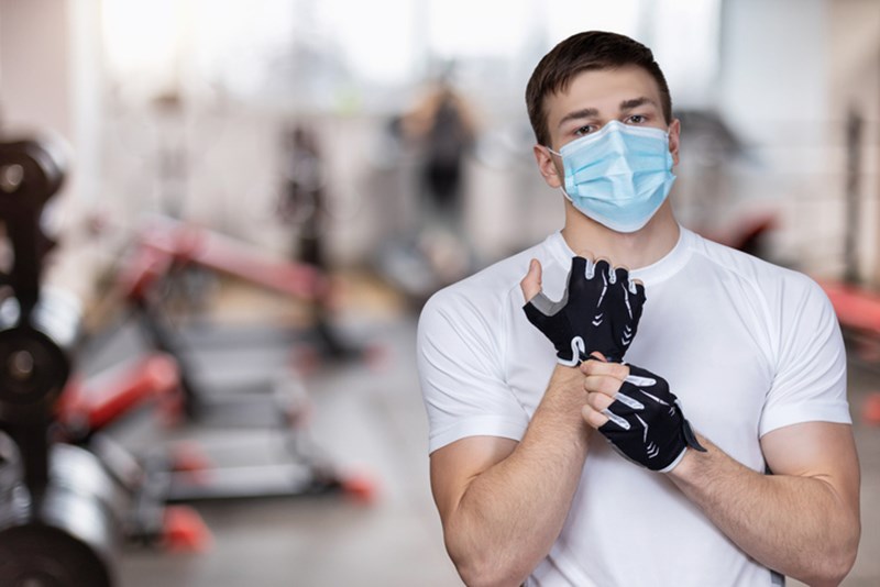 MAN WITH FACE MASK IN THE GYM