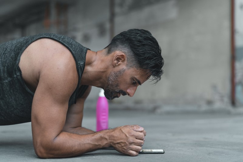 MAN EXERCISING IN PLANK POSITION