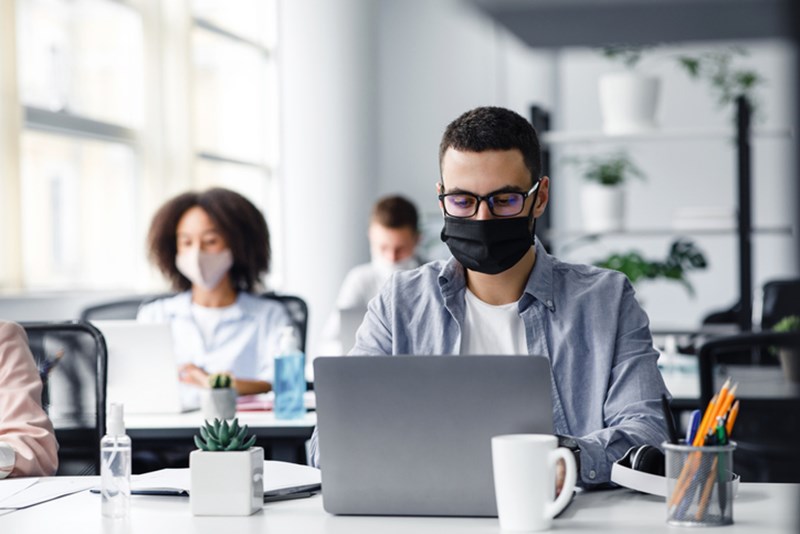OFFICE WORKERS WITH PROTECTIVE MASKS