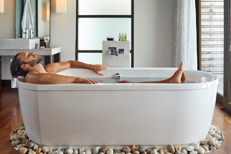 MAN SLEEPING IN THE BATHTUB